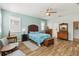 Spacious main bedroom featuring wood-look tile floors, a ceiling fan, and lots of storage at 2951 Irish Peach Dr, Winter Garden, FL 34787