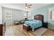 Tranquil main bedroom boasts wood-look tile floors, a ceiling fan, and a comfortable bed at 2951 Irish Peach Dr, Winter Garden, FL 34787