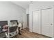 Well-lit office space with wood-look tile floors and a closet for storage at 2951 Irish Peach Dr, Winter Garden, FL 34787