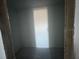 A small closet with a concrete floor and natural light at 30125 Misty Pines Rd, Mount Dora, FL 32757