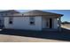The back exterior of a white, single-story home, including a covered patio at 30125 Misty Pines Rd, Mount Dora, FL 32757