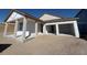 Beautiful new home exterior featuring a two-car garage and a covered front porch at 30125 Misty Pines Rd, Mount Dora, FL 32757