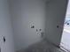 Bright, unfinished laundry room includes hookups, and an exterior door at 30125 Misty Pines Rd, Mount Dora, FL 32757