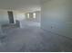 Modern living area featuring large open space and abundant natural light from multiple windows at 30125 Misty Pines Rd, Mount Dora, FL 32757