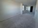 Open-concept living room featuring clean, white walls and windows at 30125 Misty Pines Rd, Mount Dora, FL 32757