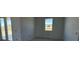 Clean living room with windows and glass doors offering ample light and a great view at 30125 Misty Pines Rd, Mount Dora, FL 32757