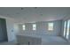 Spacious living room with large windows providing plenty of natural light and double glass doors at 30125 Misty Pines Rd, Mount Dora, FL 32757