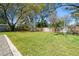 Large grassy backyard with paver trim and a wooden fence at 315 E 6Th Ave, Windermere, FL 34786