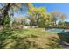 Pool area in a large backyard with a -proof fence at 315 E 6Th Ave, Windermere, FL 34786