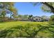 Expansive grassy backyard with a pool and a wooden fence at 315 E 6Th Ave, Windermere, FL 34786