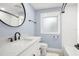 Stylish bathroom with a modern vanity, round mirror, and walk-in shower at 315 E 6Th Ave, Windermere, FL 34786