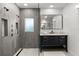 This bathroom features a glass shower enclosure and a black vanity with a marble countertop at 315 E 6Th Ave, Windermere, FL 34786