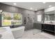 This bathroom features a standalone tub beneath a window, as well as a glass shower enclosure at 315 E 6Th Ave, Windermere, FL 34786