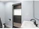 Contemporary bathroom with modern sink, sleek black tile, and unique geometric flooring at 315 E 6Th Ave, Windermere, FL 34786