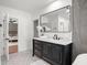 This bathroom features a black vanity with a marble countertop, and a view into the bedroom at 315 E 6Th Ave, Windermere, FL 34786