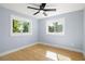 Light-filled bedroom featuring hardwood floors and windows with backyard views at 315 E 6Th Ave, Windermere, FL 34786