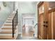 Charming entryway with hardwood floors, a staircase with a black railing, and a wood front door at 315 E 6Th Ave, Windermere, FL 34786