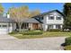 Inviting two-story home with landscaped front yard, classic white and black exterior, and paver driveway at 315 E 6Th Ave, Windermere, FL 34786
