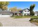 Beautifully landscaped home featuring a circular driveway and a white and black exterior at 315 E 6Th Ave, Windermere, FL 34786