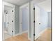 Hallway showing three entryways with white doors and black hardware at 315 E 6Th Ave, Windermere, FL 34786