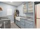 Bright laundry room with cabinets, farmhouse sink, and patterned tile floor at 315 E 6Th Ave, Windermere, FL 34786