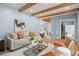 Stylish living room with wood beam ceiling, modern furniture, and bright natural light at 315 E 6Th Ave, Windermere, FL 34786