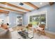 Bright living room featuring comfortable seating and a large window overlooking the landscaped yard at 315 E 6Th Ave, Windermere, FL 34786
