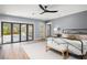 Bright main bedroom features wood floors, gray walls, and sliding doors to the exterior at 315 E 6Th Ave, Windermere, FL 34786