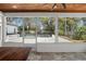 View of backyard pool from covered patio with ceiling fan and stone flooring at 315 E 6Th Ave, Windermere, FL 34786