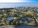 Beautiful aerial view of a community with a pool, tennis courts, and stunning lakefront property at 3279 Landing Vw, Tavares, FL 32778