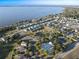 Scenic aerial view of a community with waterfront homes, a lake, tennis courts and a neighborhood pool at 3279 Landing Vw, Tavares, FL 32778