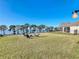 Spacious backyard with lush lawn, fire pit, and beautiful lake views, perfect for outdoor entertaining at 3279 Landing Vw, Tavares, FL 32778