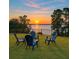 Beautiful backyard seating area overlooking the lake, perfect for relaxing and enjoying scenic views at 3279 Landing Vw, Tavares, FL 32778