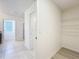 Bathroom view featuring a walk-in closet, ceramic tile flooring, and granite countertops at 3279 Landing Vw, Tavares, FL 32778