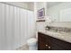 Bathroom featuring granite vanity top, white sink, and shower with a white curtain at 3279 Landing Vw, Tavares, FL 32778