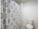 Cozy bathroom features a bathtub shower with a stylish curtain at 3279 Landing Vw, Tavares, FL 32778