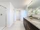 Bright bathroom featuring a glass door shower, a walk-in closet, and granite countertops at 3279 Landing Vw, Tavares, FL 32778