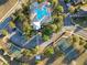 Aerial view of a community park featuring a pool, tennis courts, and playground, surrounded by trees at 3279 Landing Vw, Tavares, FL 32778