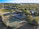 Aerial view of a community park with a pool, basketball court, parking, and green space at 3279 Landing Vw, Tavares, FL 32778