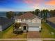 Charming two-story home boasting a paver driveway and lush landscaping at 3279 Landing Vw, Tavares, FL 32778