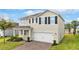 Attractive two-story home features a paved driveway and well-maintained landscaping at 3279 Landing Vw, Tavares, FL 32778