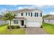 Charming home with a two-car garage and landscaped front yard at 3279 Landing Vw, Tavares, FL 32778