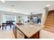 Open concept kitchen with a large island, modern appliances, and views into the living and dining areas at 3279 Landing Vw, Tavares, FL 32778