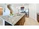 Spacious kitchen island with granite countertops, stainless steel appliances, and convenient breakfast bar seating at 3279 Landing Vw, Tavares, FL 32778