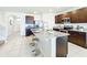Modern kitchen with a spacious island, stainless steel appliances, and a convenient breakfast bar for casual dining at 3279 Landing Vw, Tavares, FL 32778