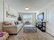Comfortable living room with a contemporary design, plush rug, and abundant natural light at 3279 Landing Vw, Tavares, FL 32778