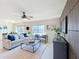 Spacious living room featuring a decorative wall, ceiling fan, and plenty of natural light at 3279 Landing Vw, Tavares, FL 32778