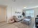 Comfortable living room featuring a large window providing natural light at 3279 Landing Vw, Tavares, FL 32778