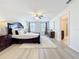 Spacious main bedroom with a ceiling fan, and an ensuite bathroom at 3279 Landing Vw, Tavares, FL 32778