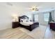 Spacious bedroom featuring a ceiling fan, two windows and an area rug over luxury vinyl plank flooring at 3279 Landing Vw, Tavares, FL 32778